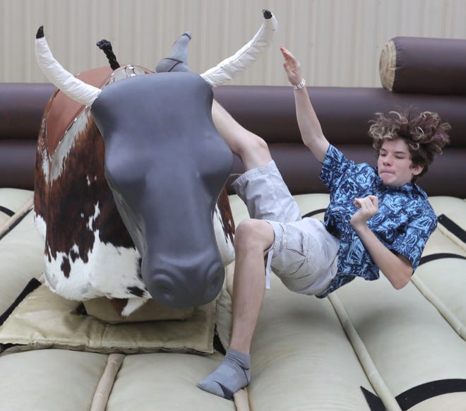 Patrick Richards celebrates his 15th birthday with a $5 bull ride at the 2021 Summit County Fair in Tallmadge.