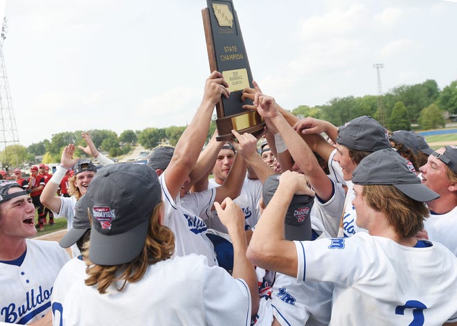 Van Meter's baseball team celebrates with the trophy after winning 10-2 against Centerville in the Class 2A state baseball championship final at Merchants Park Thursday, July 29, 2021, in Carroll, Iowa.