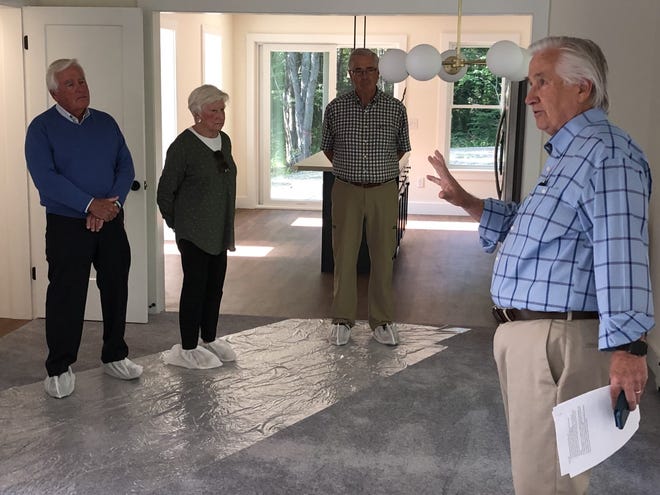 KHHT board member Patrick Clancy leads visitors on a tour of the organization's first completed home at Heritage Woods on Wednesday, July 28.