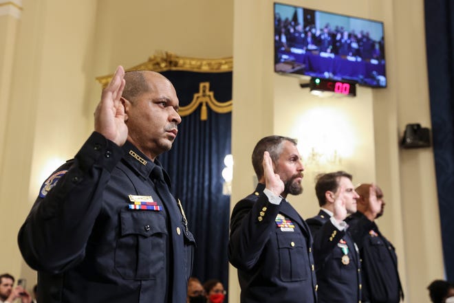 Capitol Police Sgt. Aquilino Gonell, left; Officers Michael Fanone and Daniel Hodges, of the Washington Metropolitan Police Department; and  Capitol Police Sgt. Harry Dunn are sworn in to testify before the House select committee in July about what happened when Donald Trump supporters stormed the Capitol.