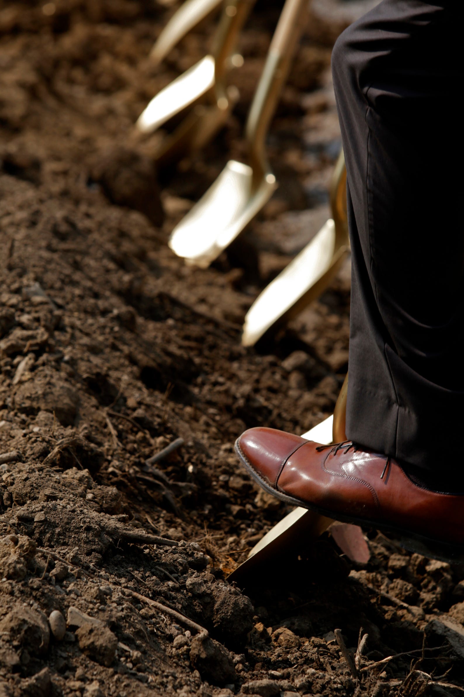 Shovels dig into the ground at the groundbreaking of the Moeller Athletic Complex on Thursday, July 29, 2021 in Miami Township. The complex will feature a baseball stadium, honor wall, practice fields, locker rooms, weight room, athletic offices and batting cages.