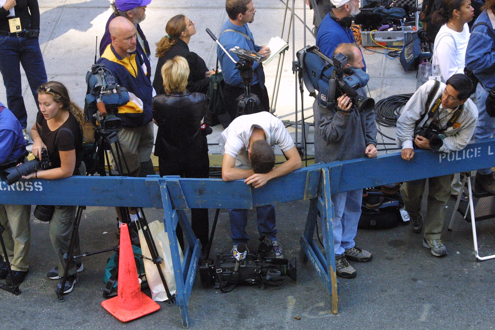 A camera man rests his head after being visibly moved during the funeral mass for NYFD Chaplain Mychal Judge at  St, Francis Cathedral on West 31st Street near 6th Ave in New York City. Saturday, September 15, 2001.