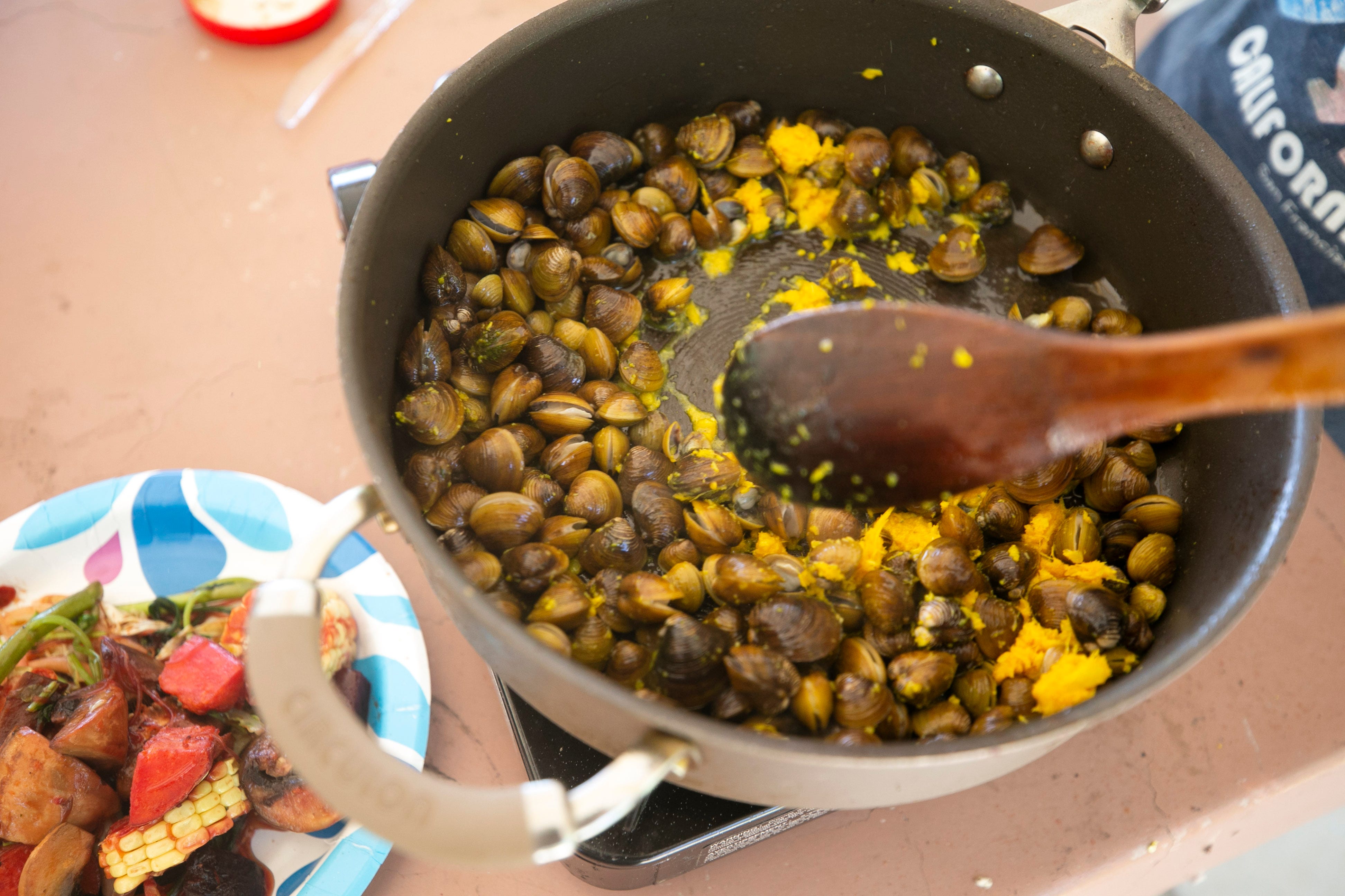 Asiatic clams just taken from the Verde River are stir-fried with kroeung, a Cambodian marinade and spice paste, at the Needle Rock Recreation Site outside of Rio Verde on July 28, 2021. These clams are a popular cuisine in Cambodia. Members of the Cambodian community in the Valley came together through a Facebook group to go clamming and then cook and eat the clams.