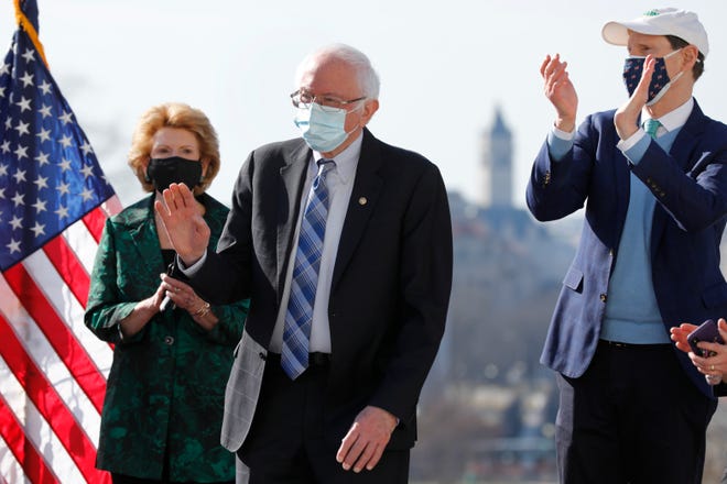 U.S. Sen. Bernie Sanders, I-Vt., is greeted during a signing ceremony the Bill Enrollment for the Biden American Rescue Plan on Capitol Hill in Washington on March 10, 2021. (Yuri Gripas/ABACA/TNS)