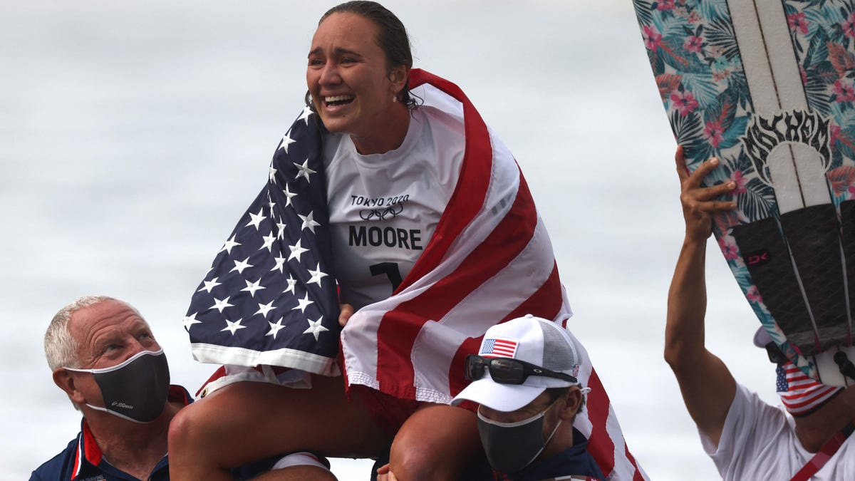 Carissa Moore celebrates after winning the women's surfing gold medal final during the Tokyo Olympic Games.