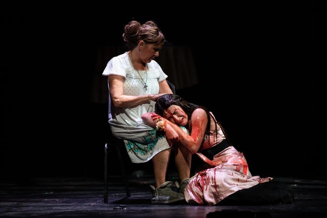 Linda Kinnison Roth, left, as Margaret and Eli Brickey as Carrie after the prom in the Columbus Immersive Theater production of “Carrie the Musical."