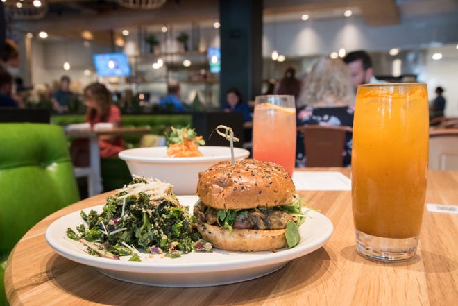 True Food Kitchen's grass-fed burger is topped with mushrooms, caramelized onion and organic arugula and served on a flaxseed bun.