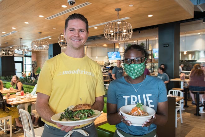 At True Food Kitchen in West Palm Beach, staffers Justin Urkoski (left) and Jaden Lawson display dishes from the menu.