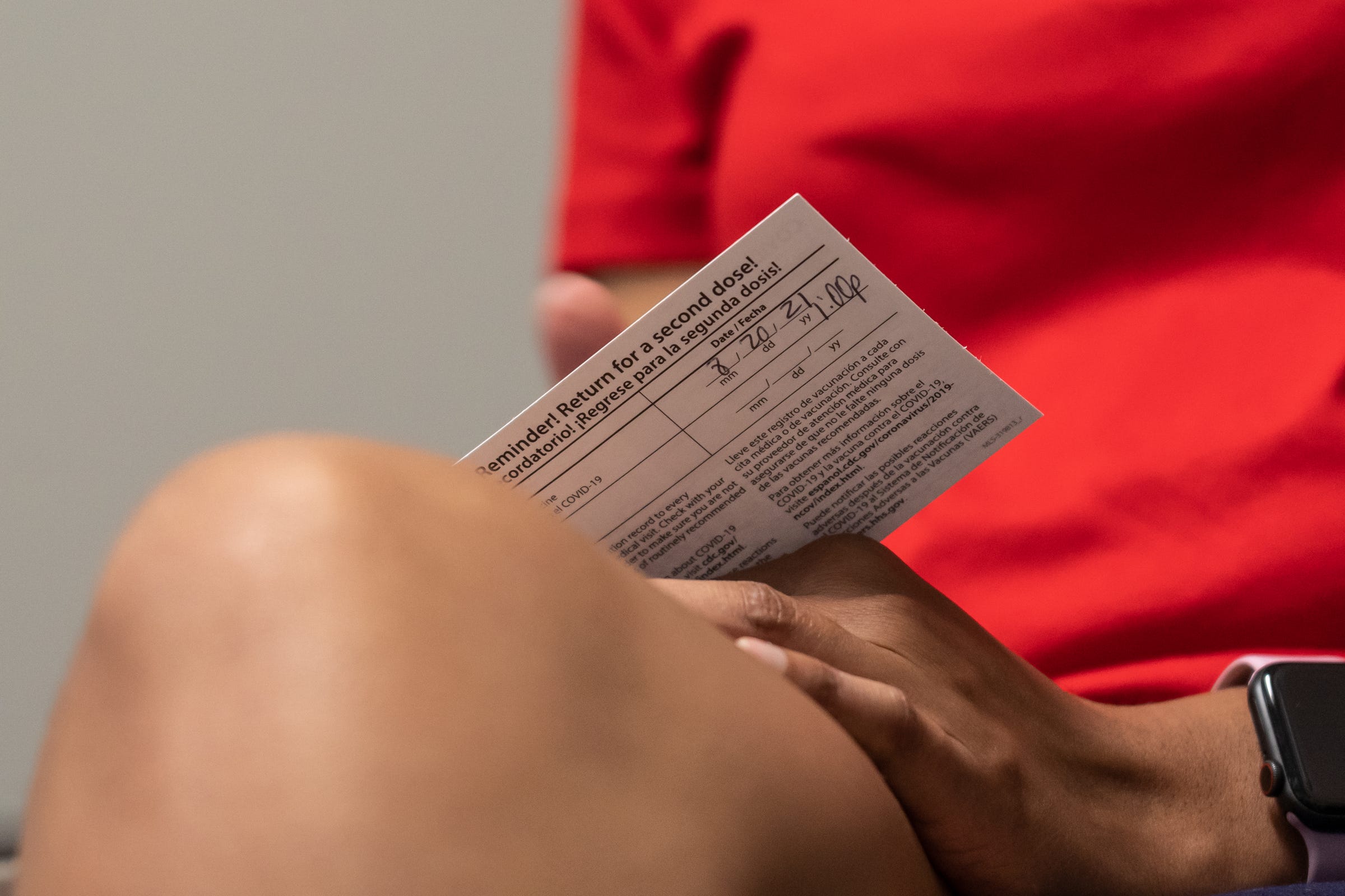 Henry Ford Health System worker Kristina Alexander (center) of Oak Park holds her vaccination card after receiving her first dose the Pfizer COVID-19 vaccine at the HAP corporate office in Detroit on Friday, July 30, 2021. Employees have been coming in to get their COVID shots due to the vaccine mandate at Henry Ford Health System. Henry Ford was the first hospital system to announce it would require all employees, students, contractors and anyone doing business within the health system to get fully vaccinated against coronavirus.