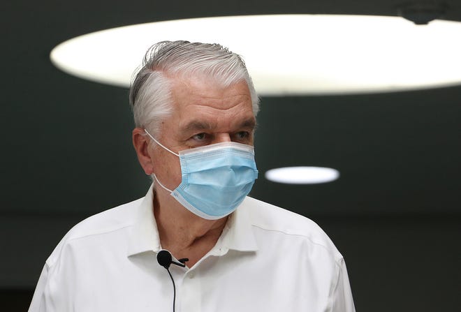 Nevada Governor Steve Sisolak is seen wearing a mask in the Downtown Reno Library on July 30, 2021.