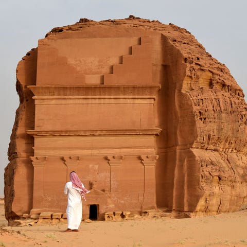 A man stands outside the Qasr al-Farid tomb (The L