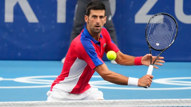 Novak Djokovic returns a shot against Alexander Zverev  in the men's singles semifinals during the Tokyo Olympics at Ariake Tennis Park.