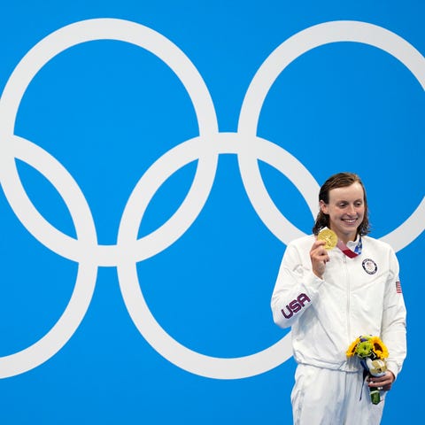 Katie Ledecky shows off her gold medal after the 8