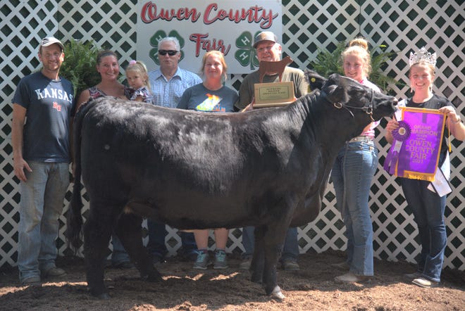 Victoria Worland won the top prize for exhibiting the Grand Champion beef heifer at the 2021 Owen County Fair. She is shown above with family and friends and 2021 OC Fair Queen Elizabeth Beeman.