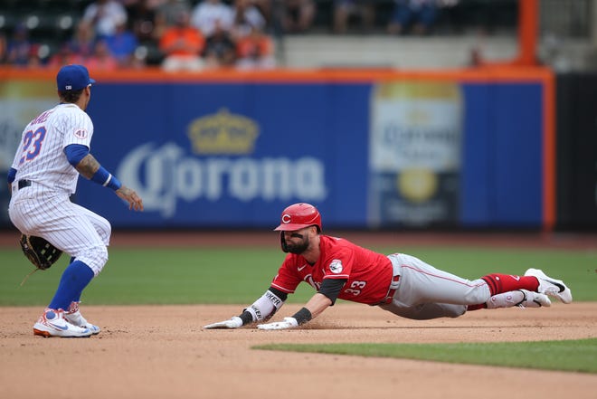 Aug 1, 2021; New York City, New York, USA; Cincinnati Reds left fielder Jesse Winker (33) slides into second base with a double in front of New York Mets shortstop Javier Baez (23) during the sixth inning at Citi Field.
