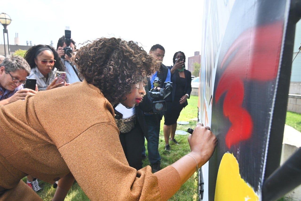 Actor Jennifer Hudson signs a mural by artist Desiree Kelly outside the Charles H. Wright Museum in  Detroit on Sunday, August 1, 2021 during a conversation for the film "Respect," in which Hudson plays Aretha Franklin.