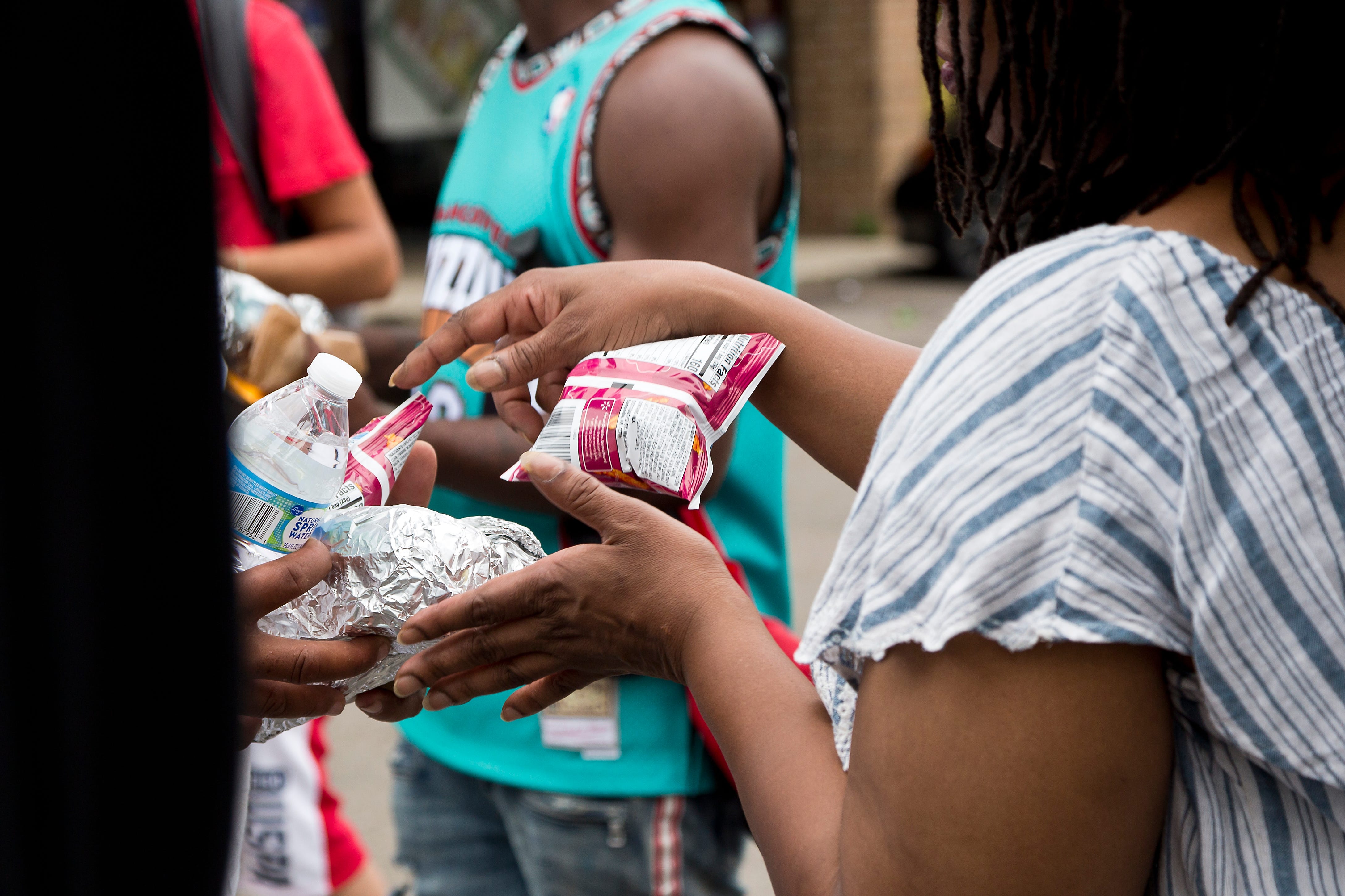 Everyday Hero finalist Debra McCauley hands out food to members of Columbus's homeless population on Thursday, July 1, 2021.