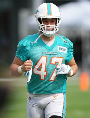 Miami Dolphins linebacker Vince Biegel runs on to the field during training camp at Baptist Health Training Complex.