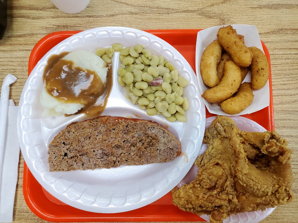 A lunch of meatloaf, mashed potatoes and gravy, fried chicken, butter beans and hush puppies. Sweet tea not pictured.