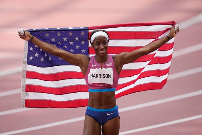 Keni Harrison celebrates after winning the silver medal in the women's 100-meter hurdles at the Tokyo Olympics.