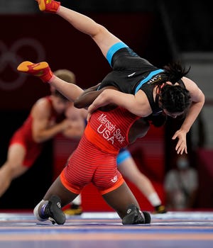 Tamyra Stock Mensah (USA) competes against Zhou Feng (CHN) in a women's freestyle match at the Tokyo Olympics.