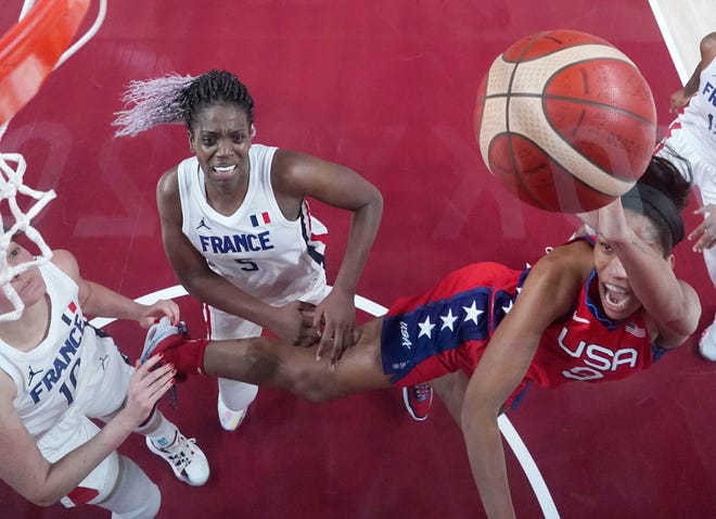 A'ja Wilson shoots while being defended by France player Sarah Michel.