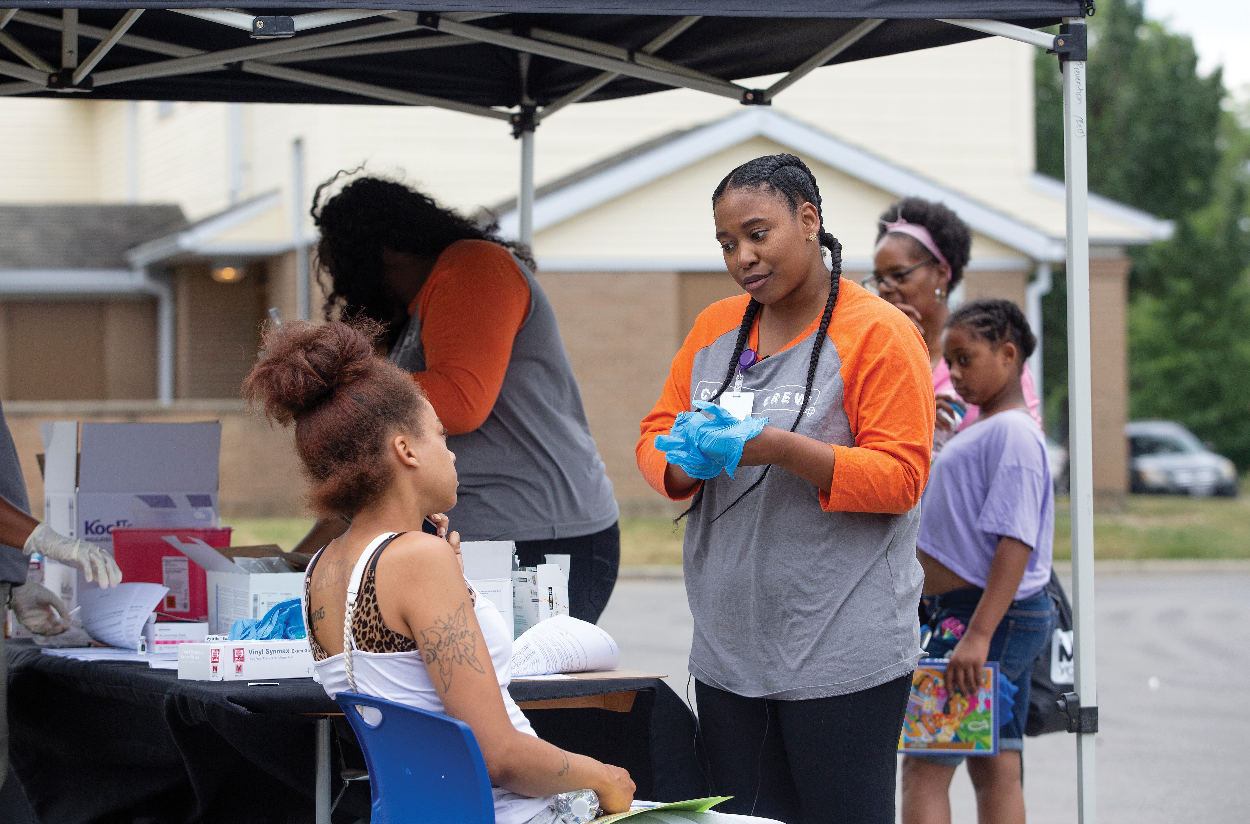 Equitas pharmacist Olivia Nathan gives vaccine information to Ka-Ron Martin during a community outreach event that provided free COVID vaccines to the public. (Photo by Tim Johnson)