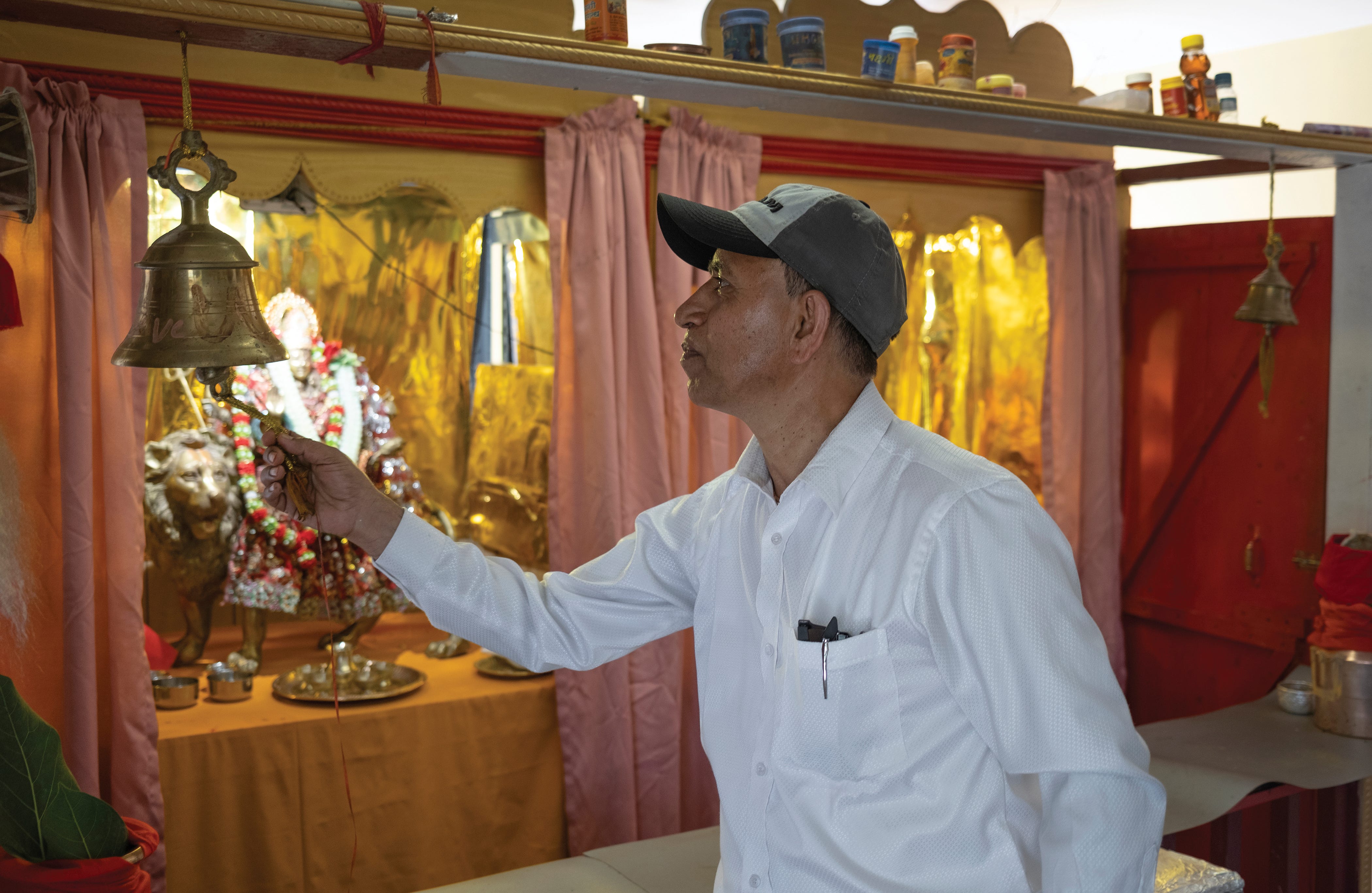 Ram Upreti rings a bell while saying prayers during a Threading Ceremony.