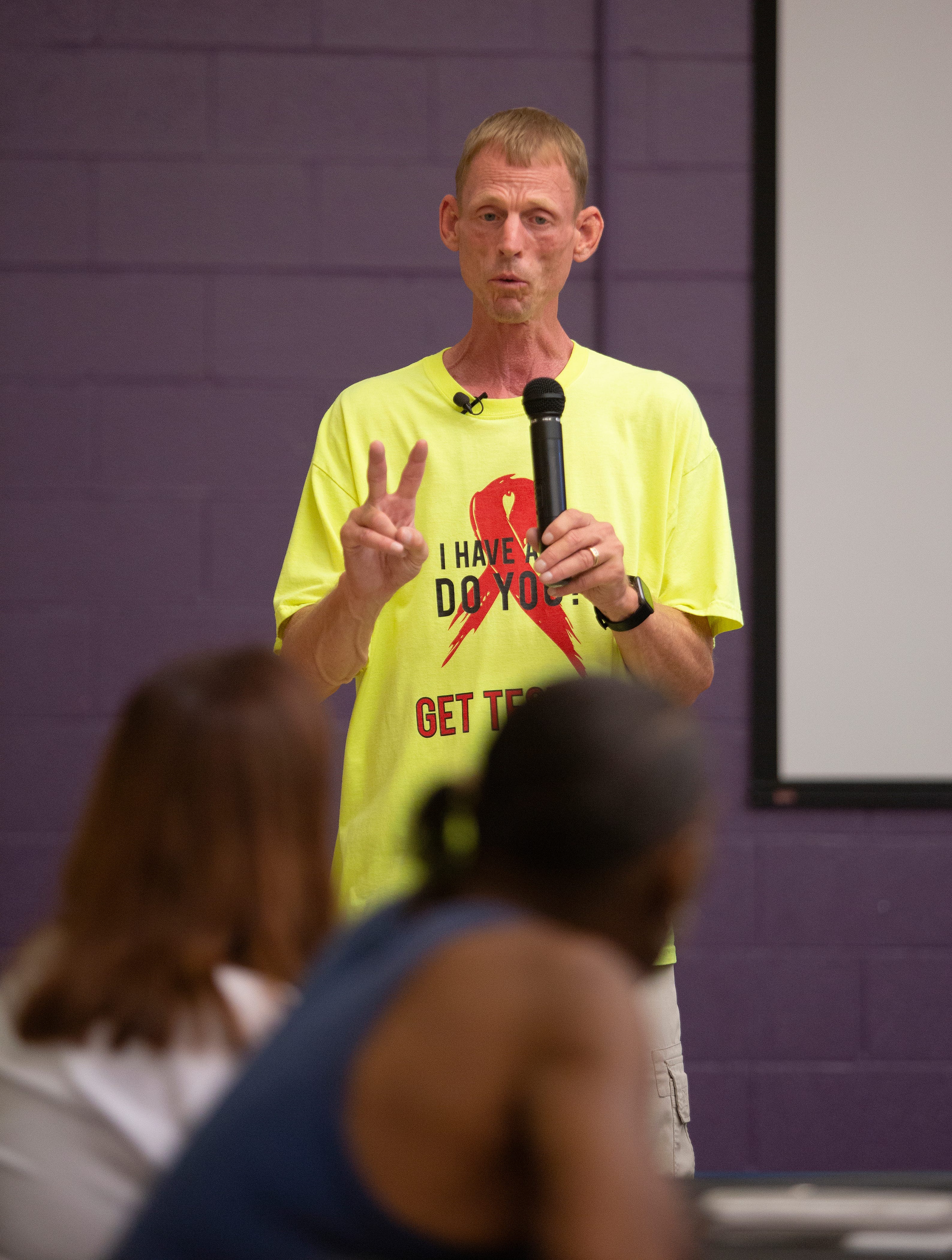 Dave Baker gives information on using condoms to greatly reduce chances of getting or spreading Aids during one of his events at the Milo Grogan Community Center. Baker is passionate about spreading the word on HIV/Aids causes and prevention in Black neighborhoods.