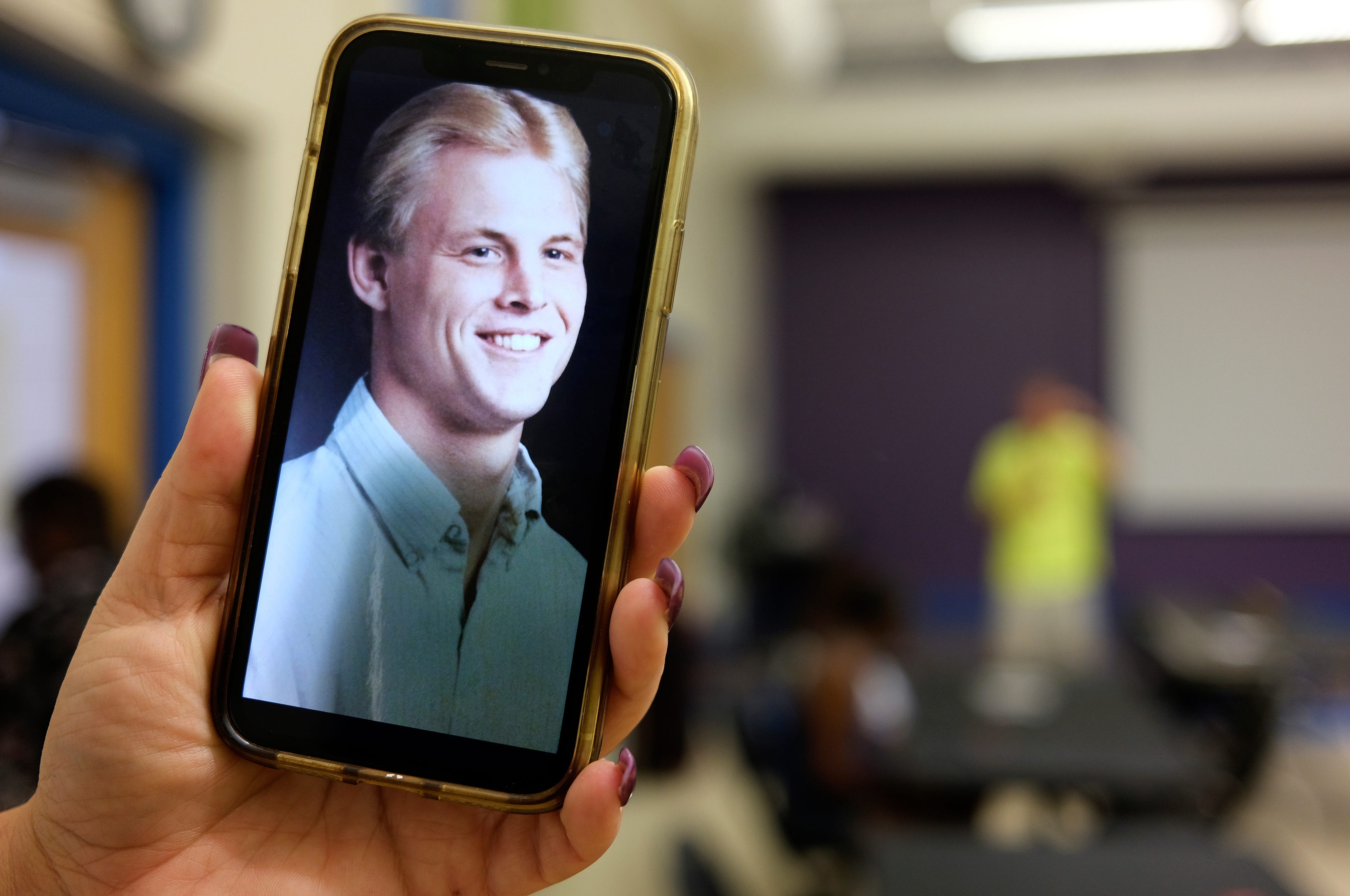 Mindy Baker keeps a photo of Dave Baker as a young man on her cell phone.