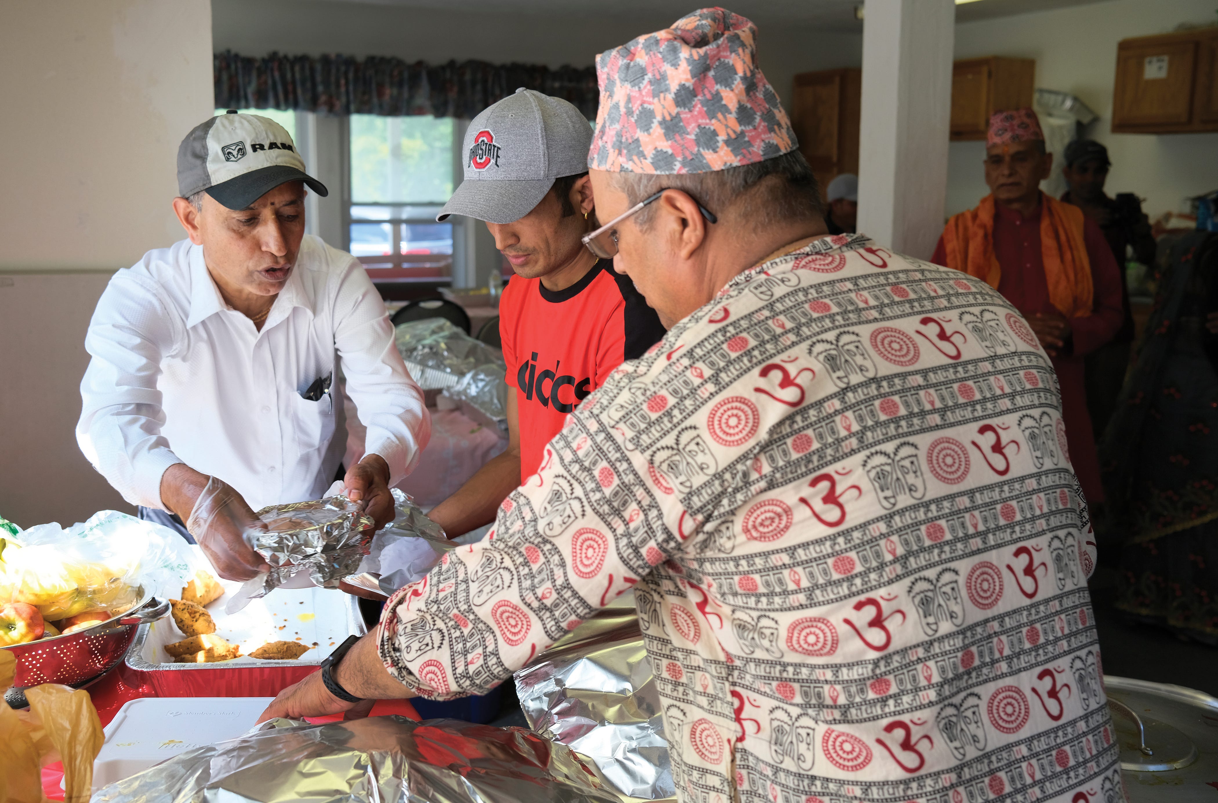 Ram Upreti helps prepare food for guests at the non-profit Vedic Welfare Society in Westerville during a Threading Ceremony.