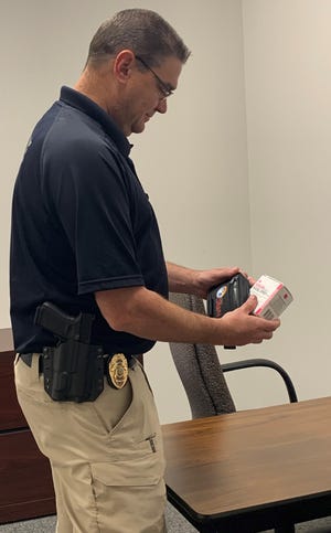 Cambridge Police Capt. Dave Peoples examines the Naloxone (also known as Narcan) kits provided by the Ohio Department of Health through the Project DAWN program. The kits provide life-saving medication in the event of an overdose.