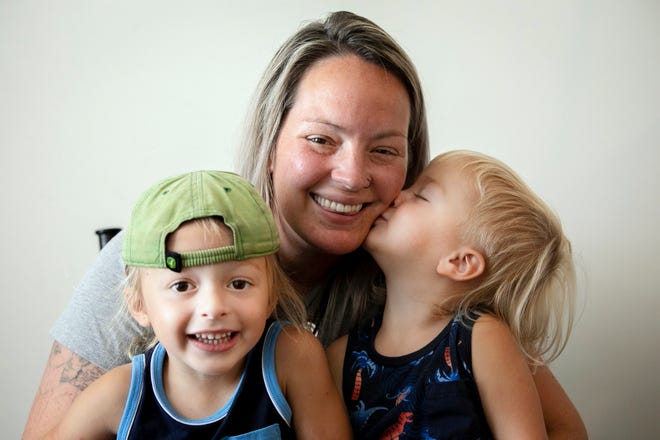 Brittany Hurley sits with her sons, Axl, 3, and Journey, 2, in her Crittenden home. Hurley is in recovery and takes methadone medication for opioid use disorder. She advocates for moms like her and has recently earned peer mentor certification, which allows her to work with other people with addiction.