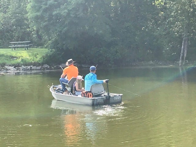 Fishing the waters of Lake Ahquabi on July 19, 2021 are Bryant Vanderpool, left, and Charolette Vanderpool of Michellville, and Bill Vanderpool of Prairie City. That's three generations fishing for bass--dad, daughter and grandfather. The Iowa Department of Natural Resources is draining the lake in preparation of a two-year restoration project.