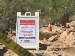 Signs at the closed Cholla Trailhead on Camelback Mountain on Tuesday, Aug. 3, 2021.