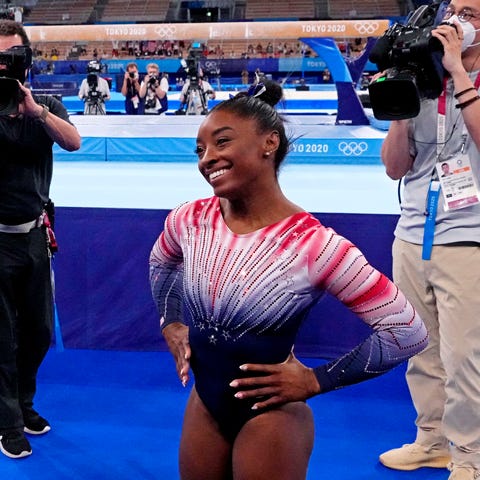 Simone Biles smiles after competing on the balance