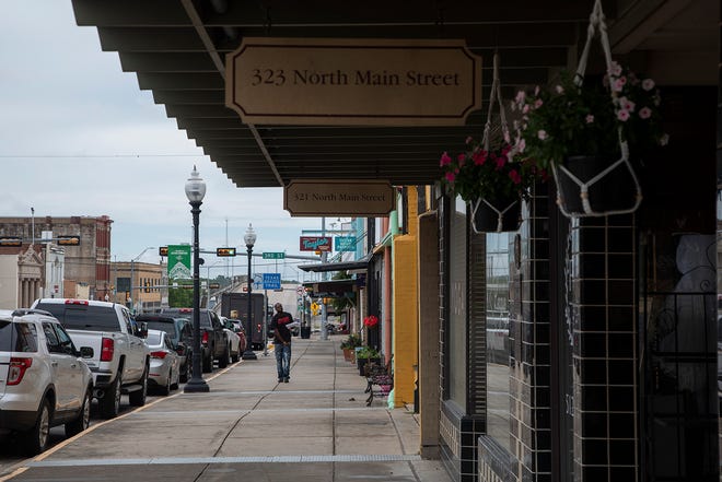 A man walks down Main Street in Taylor in August. Samsung says it is considering a site near Taylor and a site near its current Austin facility as potential homes for its planned $17 billion chipmaking plant.