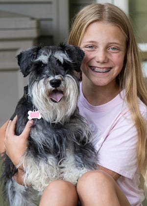Gracyn Arlidge and her miniature schnauzer Dexter outside their Chillicothe, Ohio, home. Arlidge’s project  “You and Your Dog” focuses on all aspects of dog care. 
