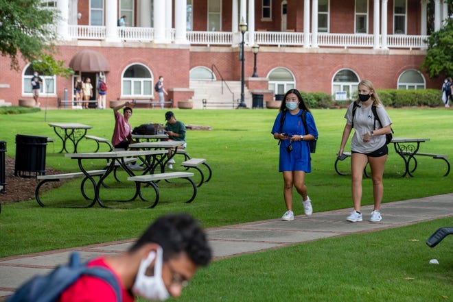College students walk through campus in Milledgeville, Ga., on Aug. 21, 2021.