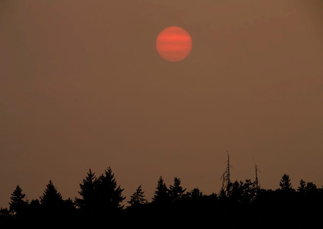 The sun sets over Eugene behind a blanket of thick smoke from wildfires burning on Aug. 5.