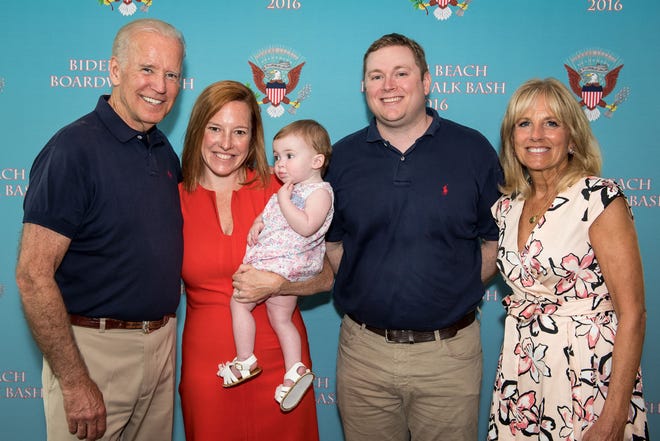 Greg Mecher, second from the right, stands with his wife, Jen Psaki, one of his children and the Bidens.