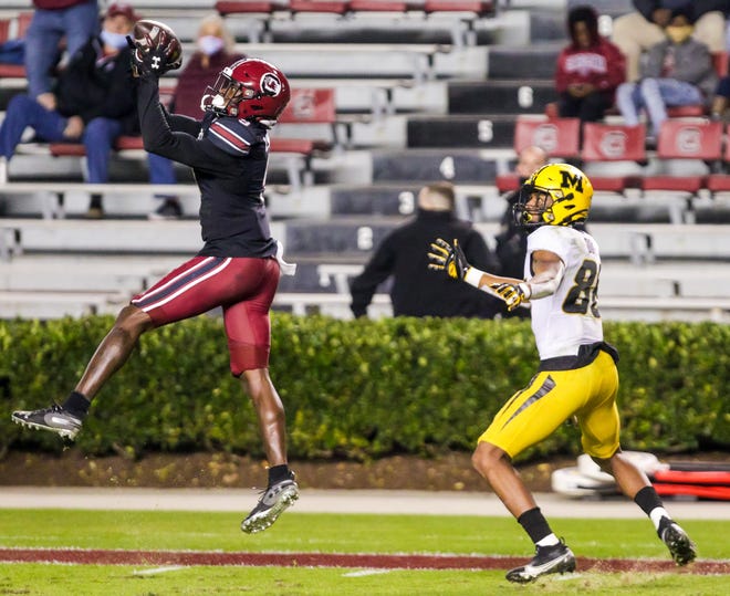 Nov 21, 2020; Columbia, South Carolina, USA; South Carolina Gamecocks defensive back Cam Smith (left) intercepts a pass intended for Missouri Tigers wide receiver Tauskie Dove (86) in the second quarter at Williams-Brice Stadium. Mandatory Credit: Jeff Blake-USA TODAY Sports