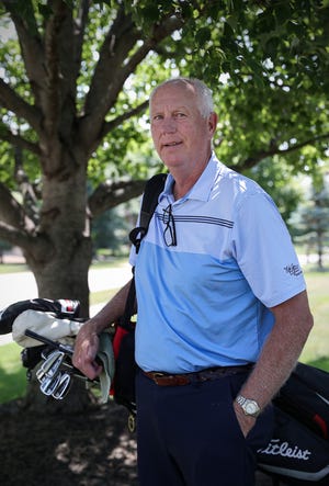 Former Indiana University basketball standout Ted Kitchel stands with golf clubs in front of his home in Greenwood on Thursday, Aug. 5, 2021.