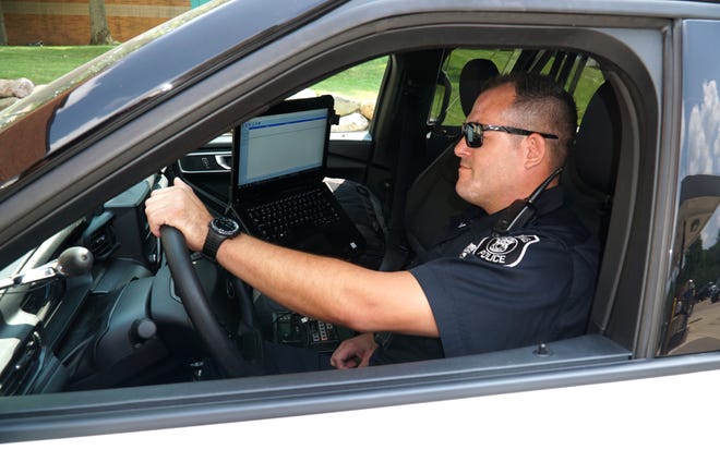                                Farmington Hills Police Officer John Hammer prepares to head out on patrol on Aug. 5, 2021.