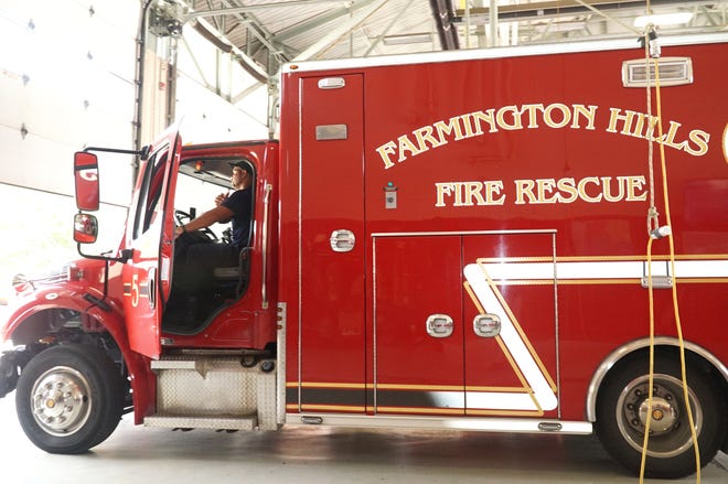     Farmington Hills firefighter Stan Bailey prepares to take its Station 5 ambulance out of the bay. This ambulance costs the city about $265 thousand.                        