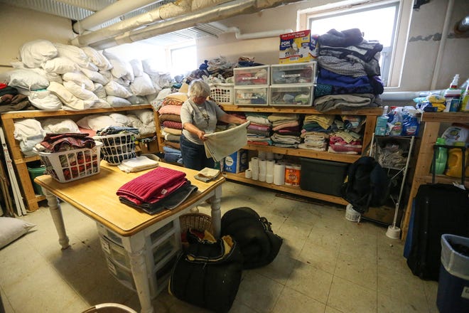 Pat Kufel Ebben of Neenah does laundry Thursday, August 5, 2021 at the Day By Day warming shelter in Oshkosh, Wis. The shelter resumed operations after a three-week hiatus from Dec. 21, 2022 to Jan. 9, 2023.