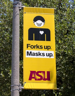 A sign that says "Forks up. Masks up." is shown on Arizona State University's campus in downtown Phoenix on Aug. 5. The purpose of the sign is to encourage students to protect themselves and others from COVID-19.