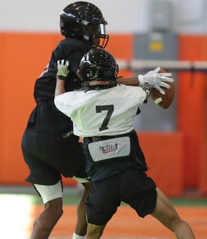 Massillon receiver Ardell Banks pulls in a pass as he is defended by Zahnii Berry during a recent practice.
