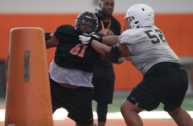 Massillon defensive lineman Reece Turpin fights through the block of Marcus Moore during a one-on-one drill in a recent practice.