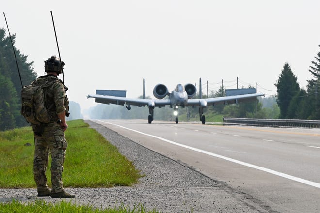 A U.S. Air Force 127th Wing A-10 Thunderbolt II, with ground air traffic control and guidance provided by Special Tactics operators from the 24th Special Operations Wing, lands on a closed public highway Thursday near Alpena, Michigan as part of a training exercise. The joint exercise tested part of the agile employment concept, focusing on projecting combat power from austere locations.